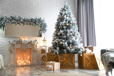 Stylish interior with decorated Christmas tree in living room