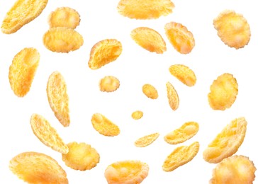 Golden corn flakes whirling on white background