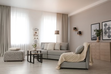 Photo of Modern living room interior with comfortable sofa near window