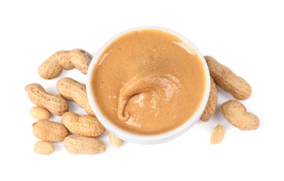 Photo of Delicious nut butter and peanuts isolated on white, top view