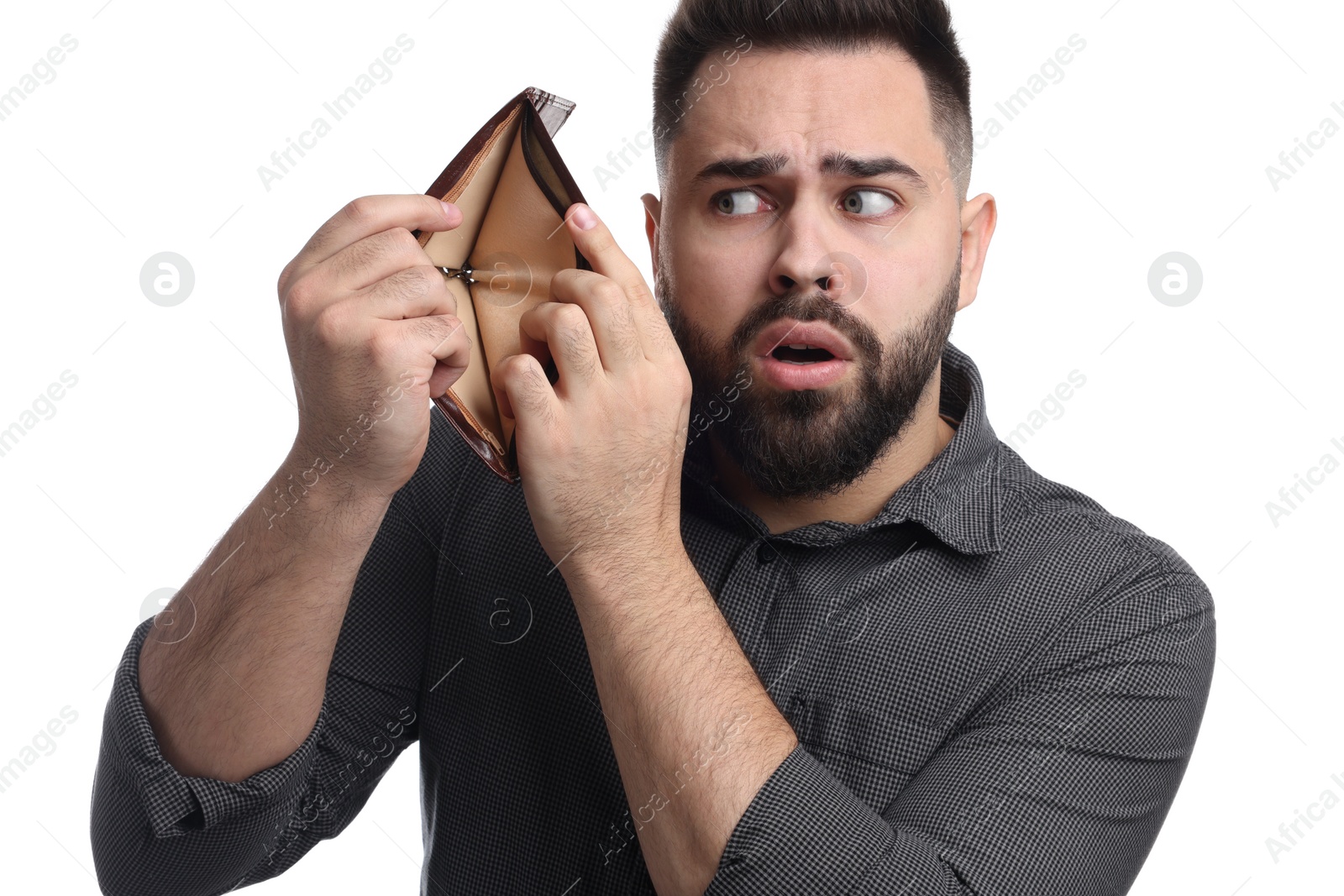 Photo of Confused man showing empty wallet on white background