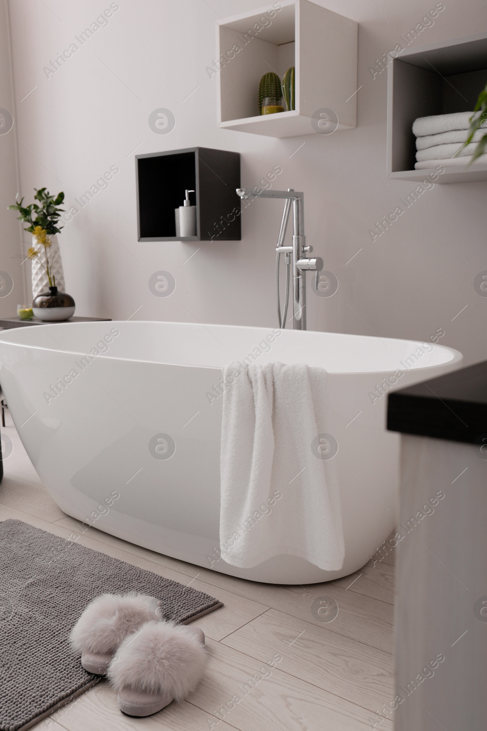 Photo of Stylish bathroom interior with modern white tub