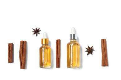 Photo of Flat lay composition with cinnamon essential oil on white background