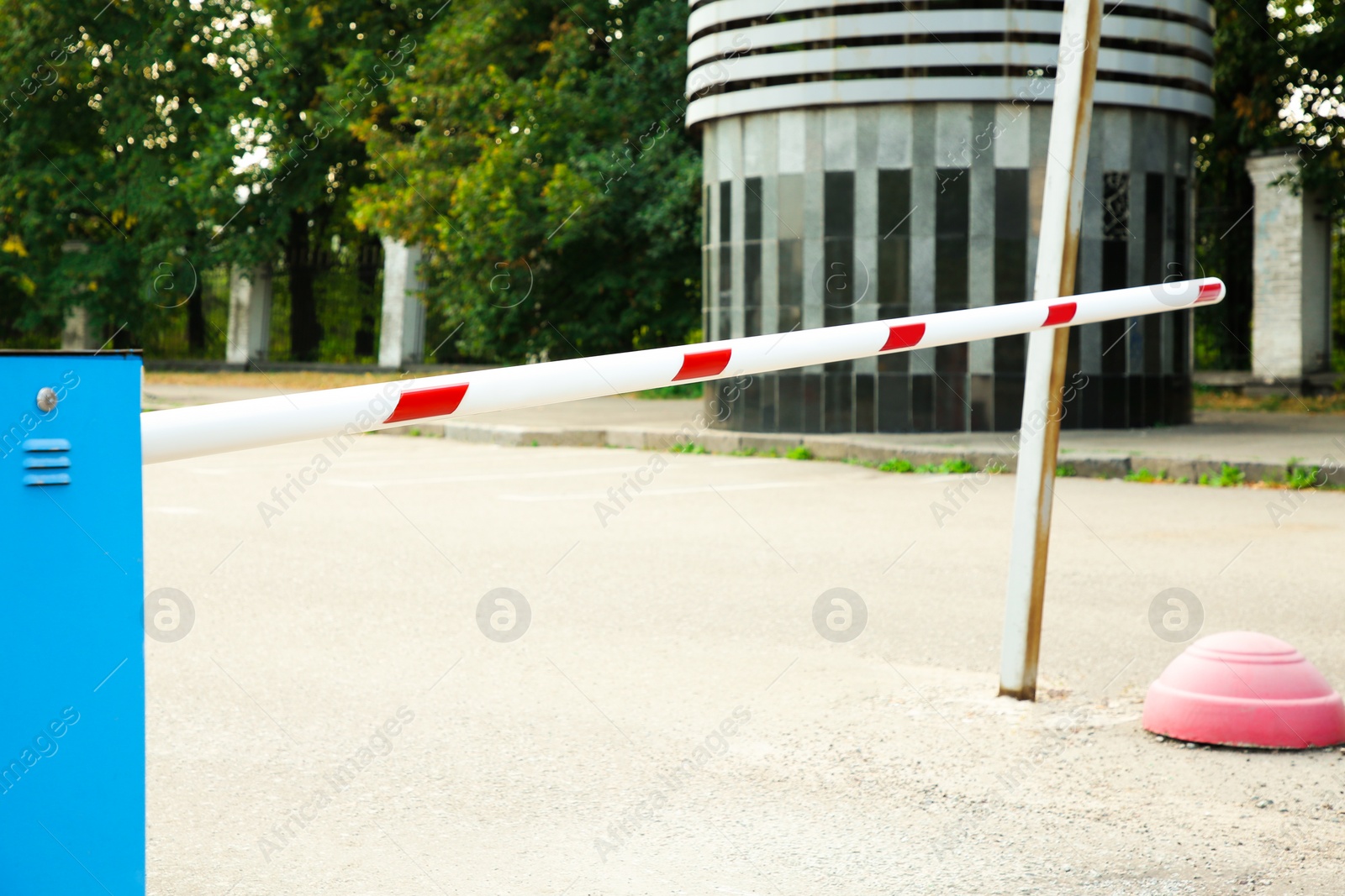 Photo of Closed boom barrier outdoors on sunny day