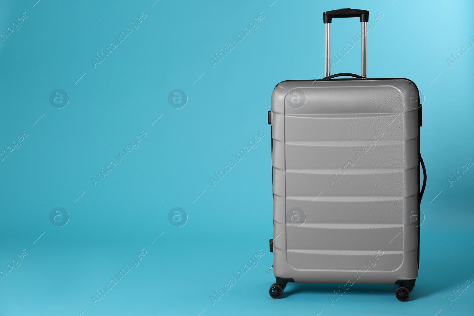 Photo of Stylish suitcase on color background. Space for text