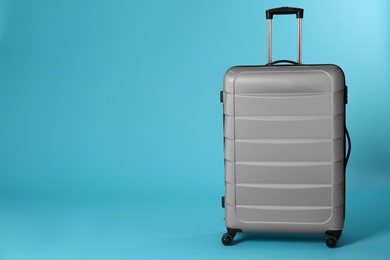 Photo of Stylish suitcase on color background. Space for text