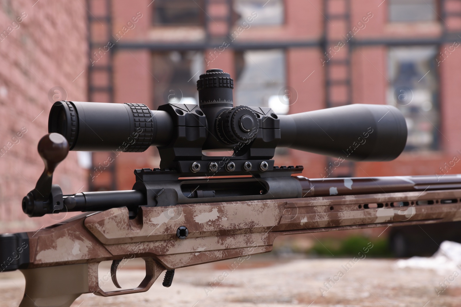 Photo of Closeup view of modern powerful sniper rifle with telescopic sight outdoors