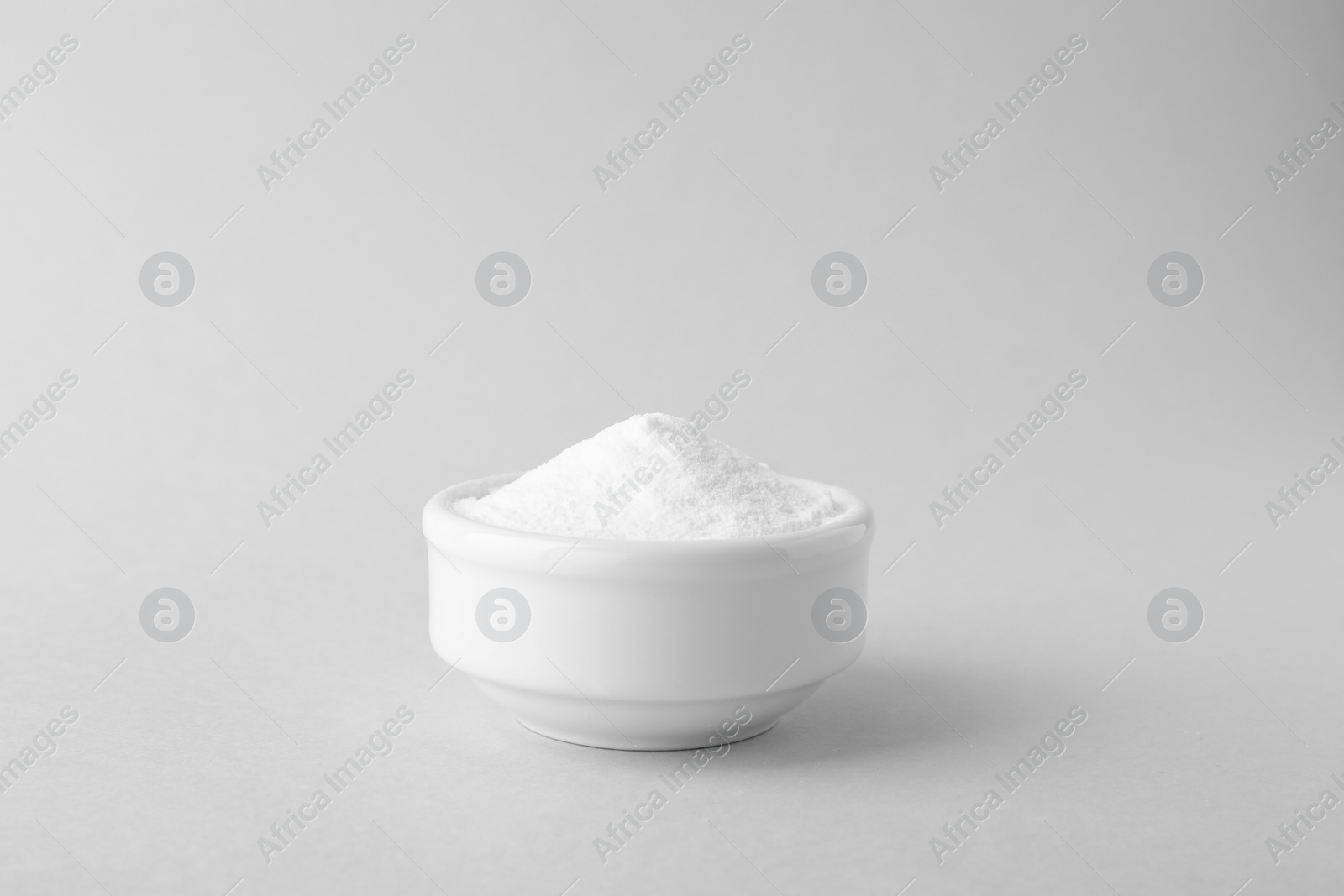 Photo of Bowl of sweet fructose powder isolated on white