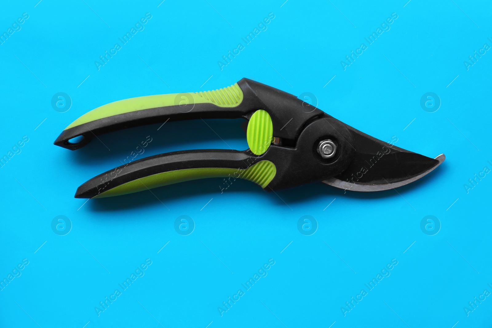 Photo of Secateur on light blue background, top view