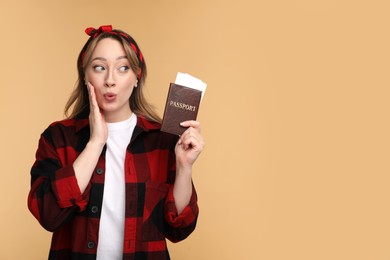 Emotional young woman with passport and ticket on beige background, space for text