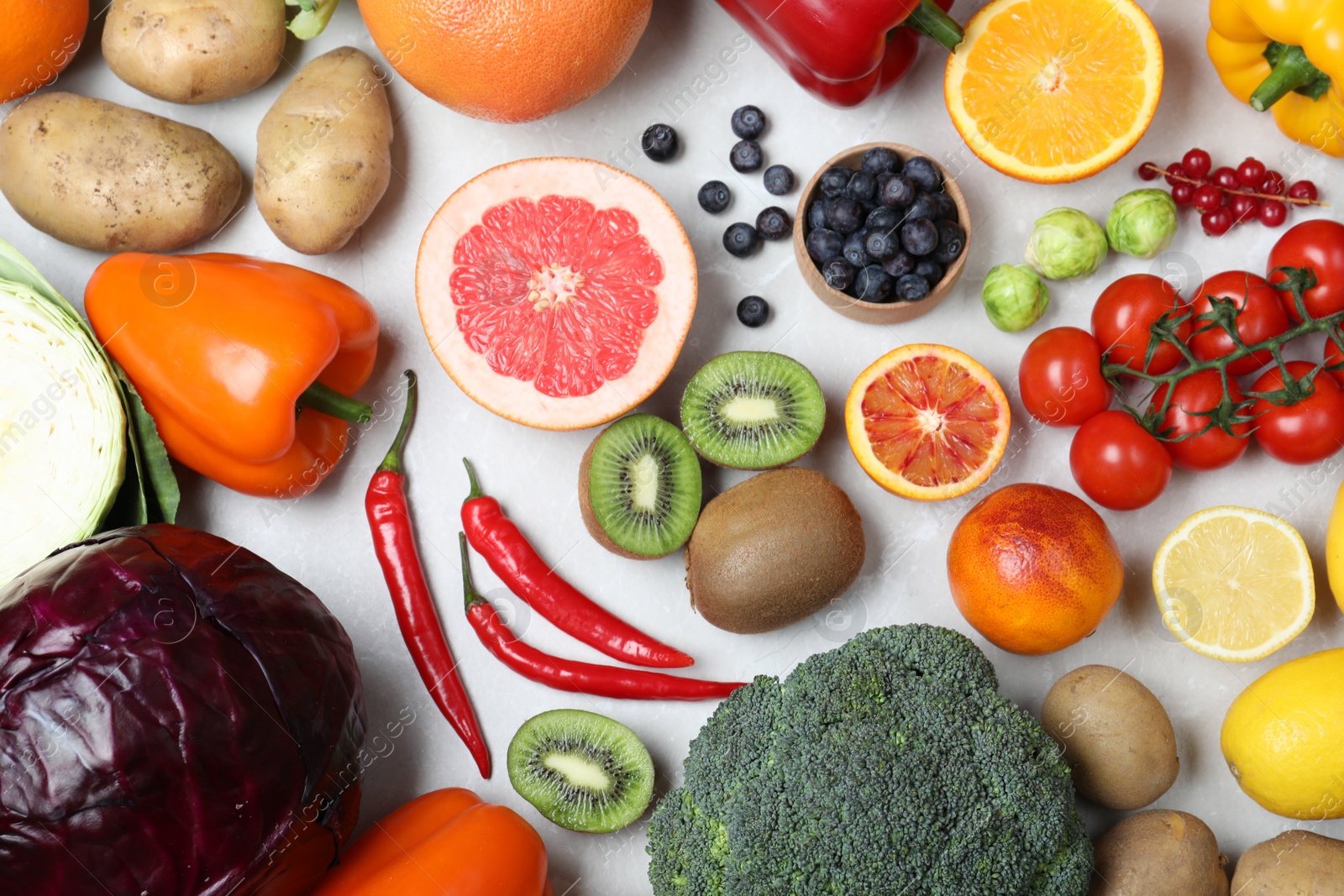 Photo of Fresh products rich in vitamin C on light table, flat lay