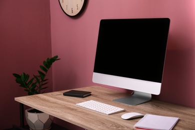 Photo of Comfortable workplace with computer on desk in home office