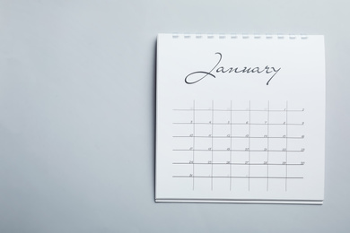 Photo of January calendar on light grey background, top view. Space for text
