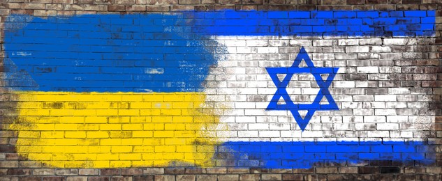 Image of International relations. National flags of Ukraine and Israel painted on brick wall, banner design