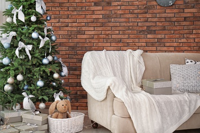 Decorated Christmas tree in stylish living room interior