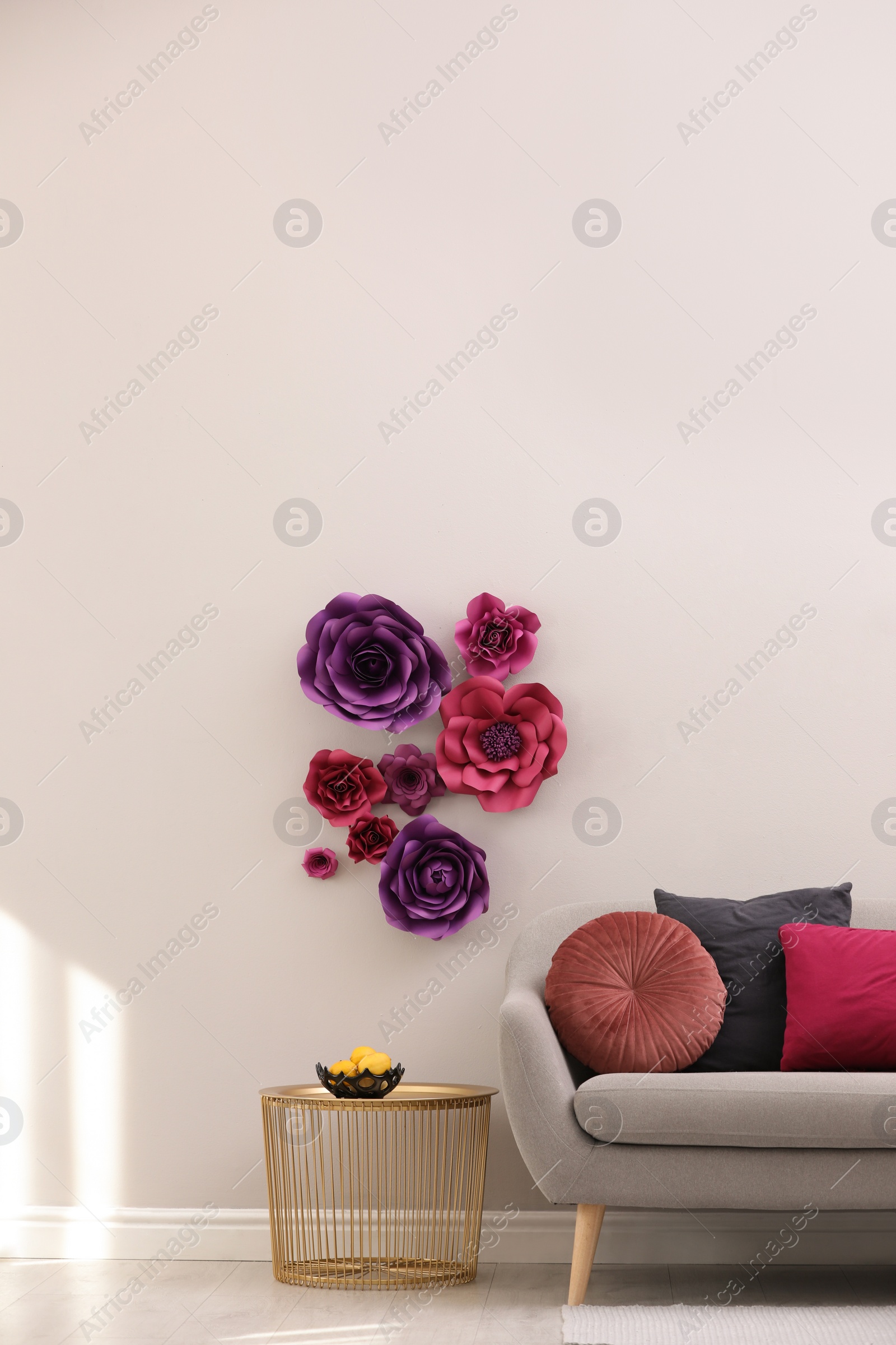 Photo of Stylish living room interior with floral decor and comfortable sofa, space for text