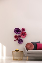 Photo of Stylish living room interior with floral decor and comfortable sofa, space for text