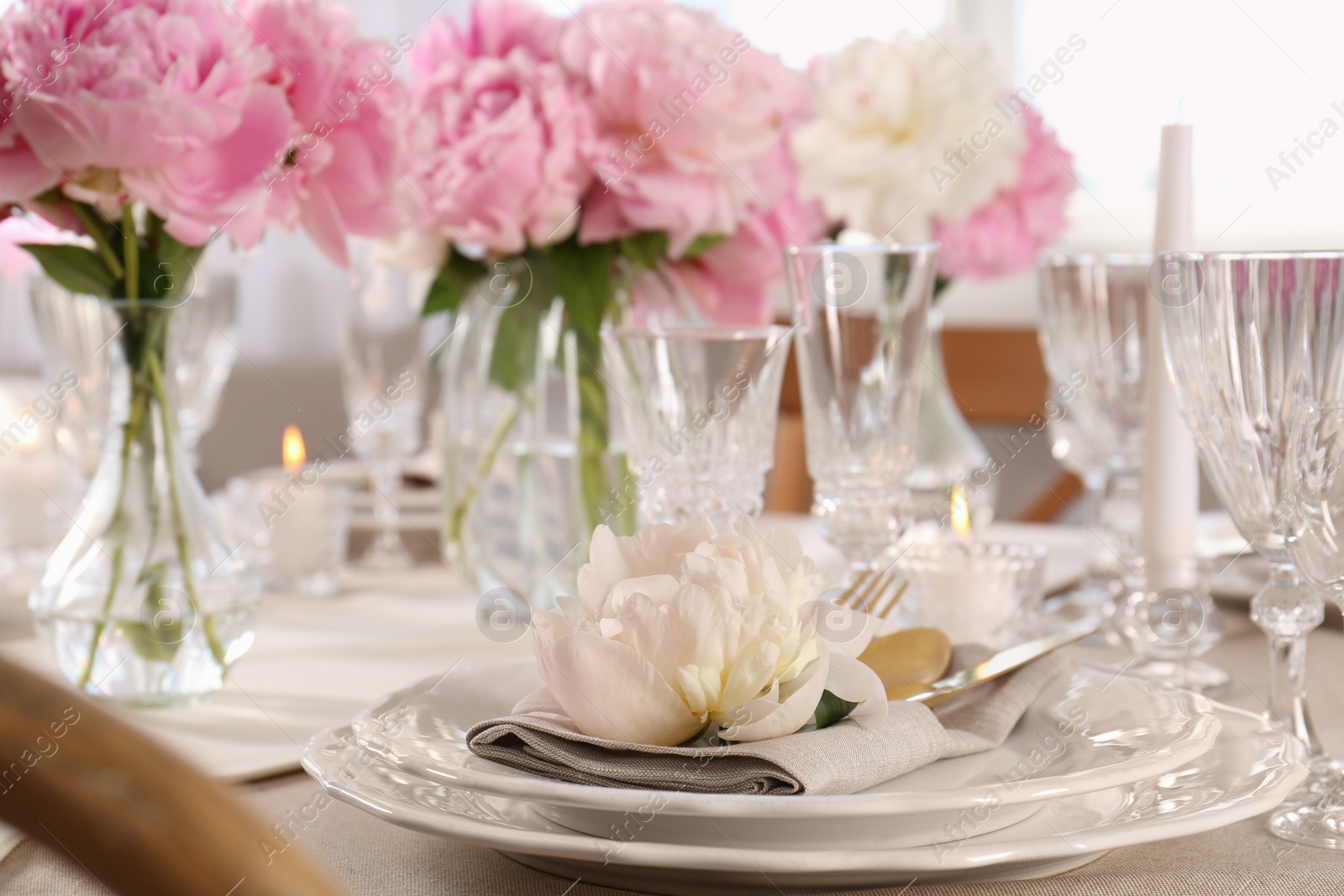 Photo of Stylish table setting with beautiful peonies indoors, closeup. Space for text