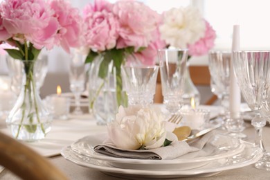 Photo of Stylish table setting with beautiful peonies indoors, closeup. Space for text