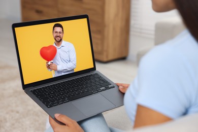 Image of Long distance love. Woman having video chat with her boyfriend via laptop at home, closeup