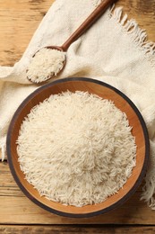 Photo of Raw basmati rice on wooden table. flat lay