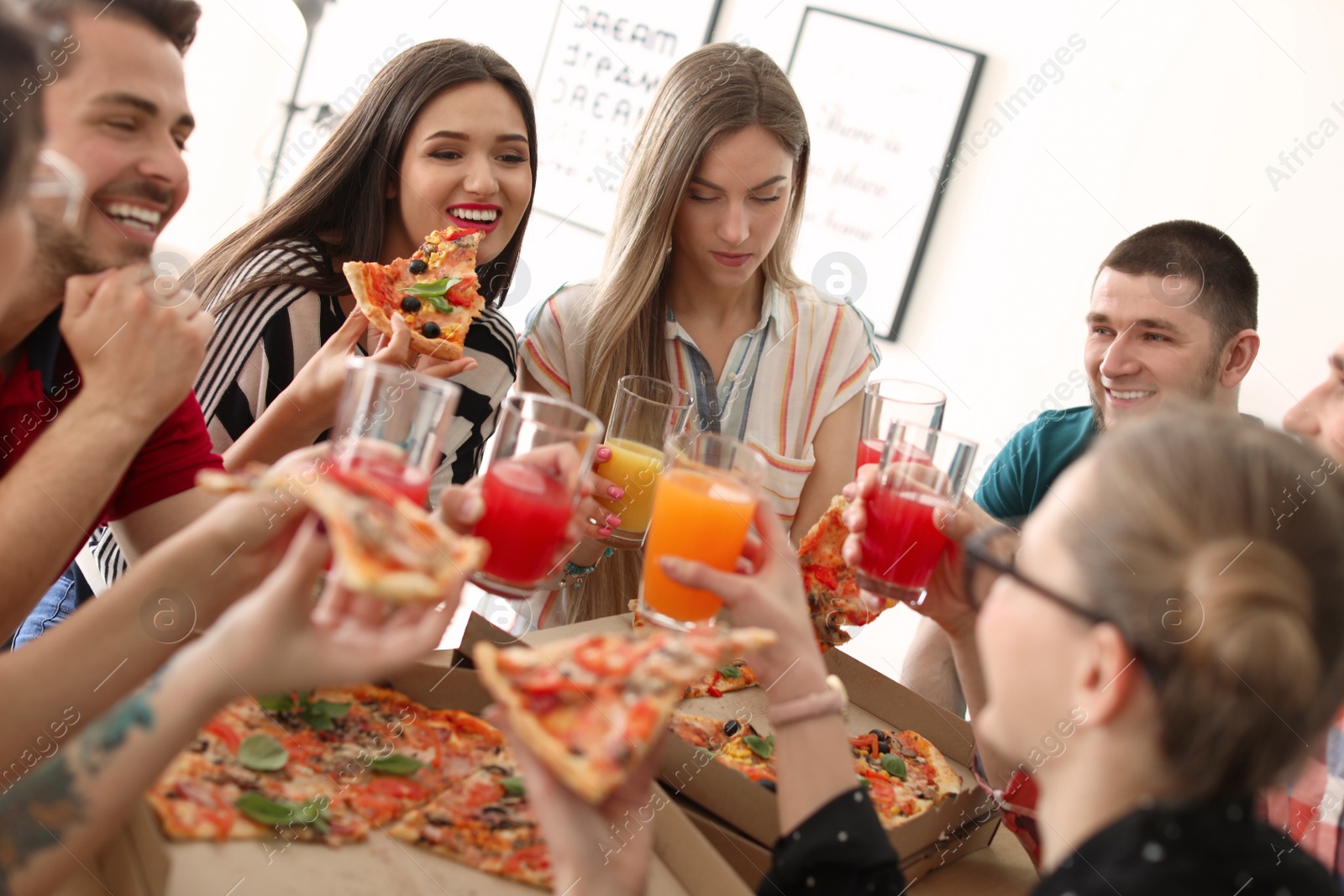 Photo of Young people having fun party with delicious pizza indoors