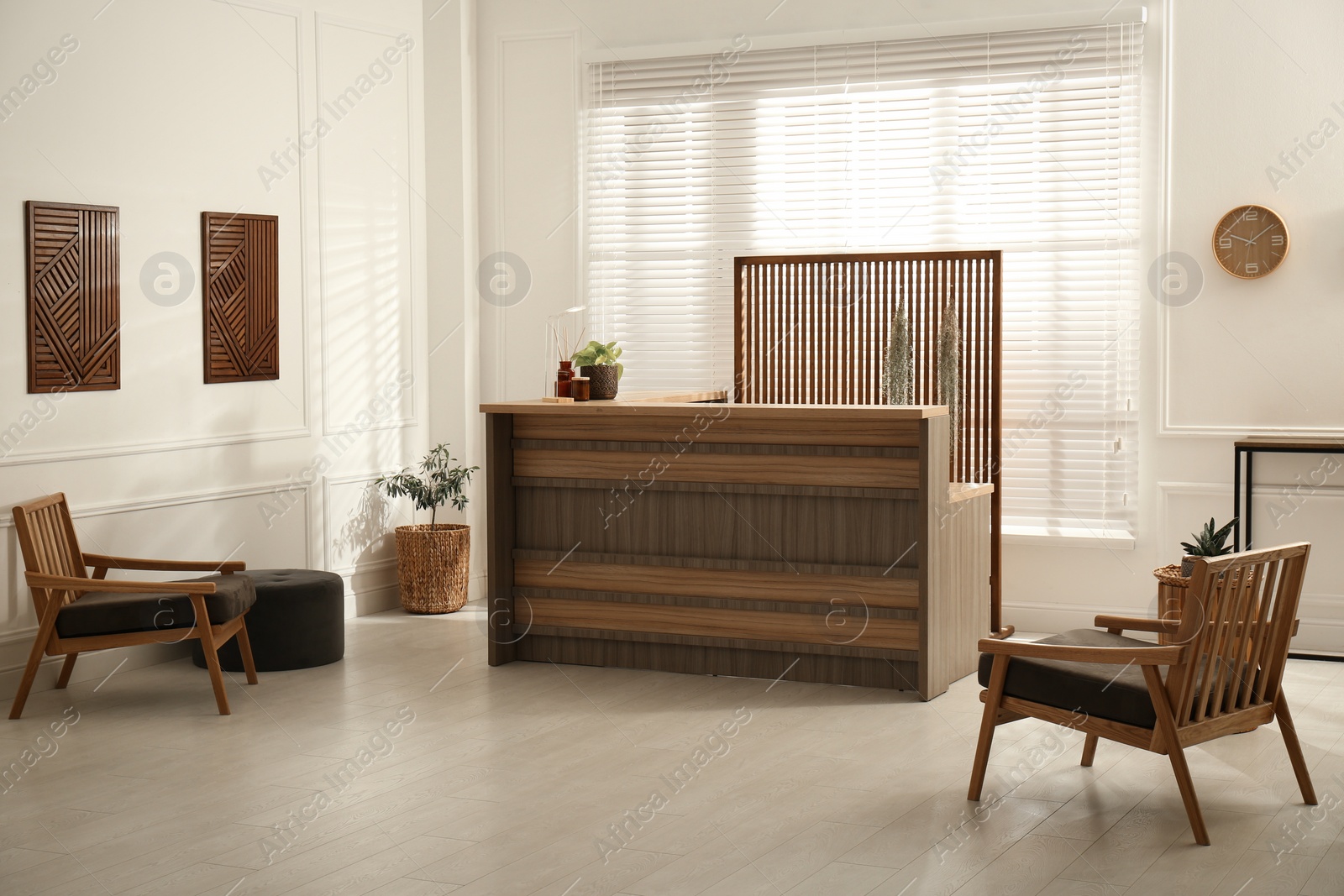 Photo of Stylish hotel lobby interior with wooden reception desk and armchairs