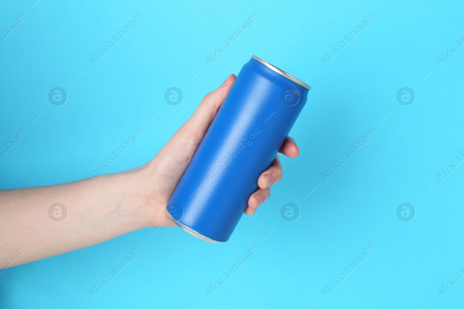 Photo of Woman with energy drink on light blue background, closeup