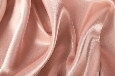 Photo of Texture of rose gold silk as background, closeup