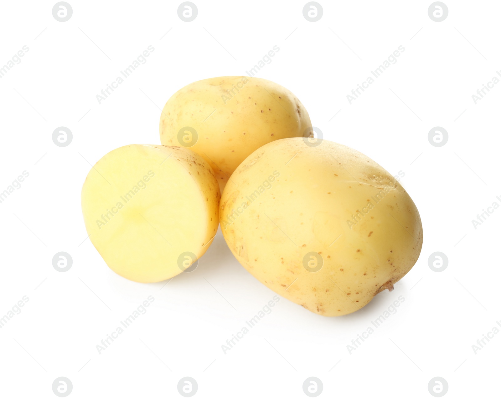 Photo of Whole and cut fresh raw organic potatoes on white background