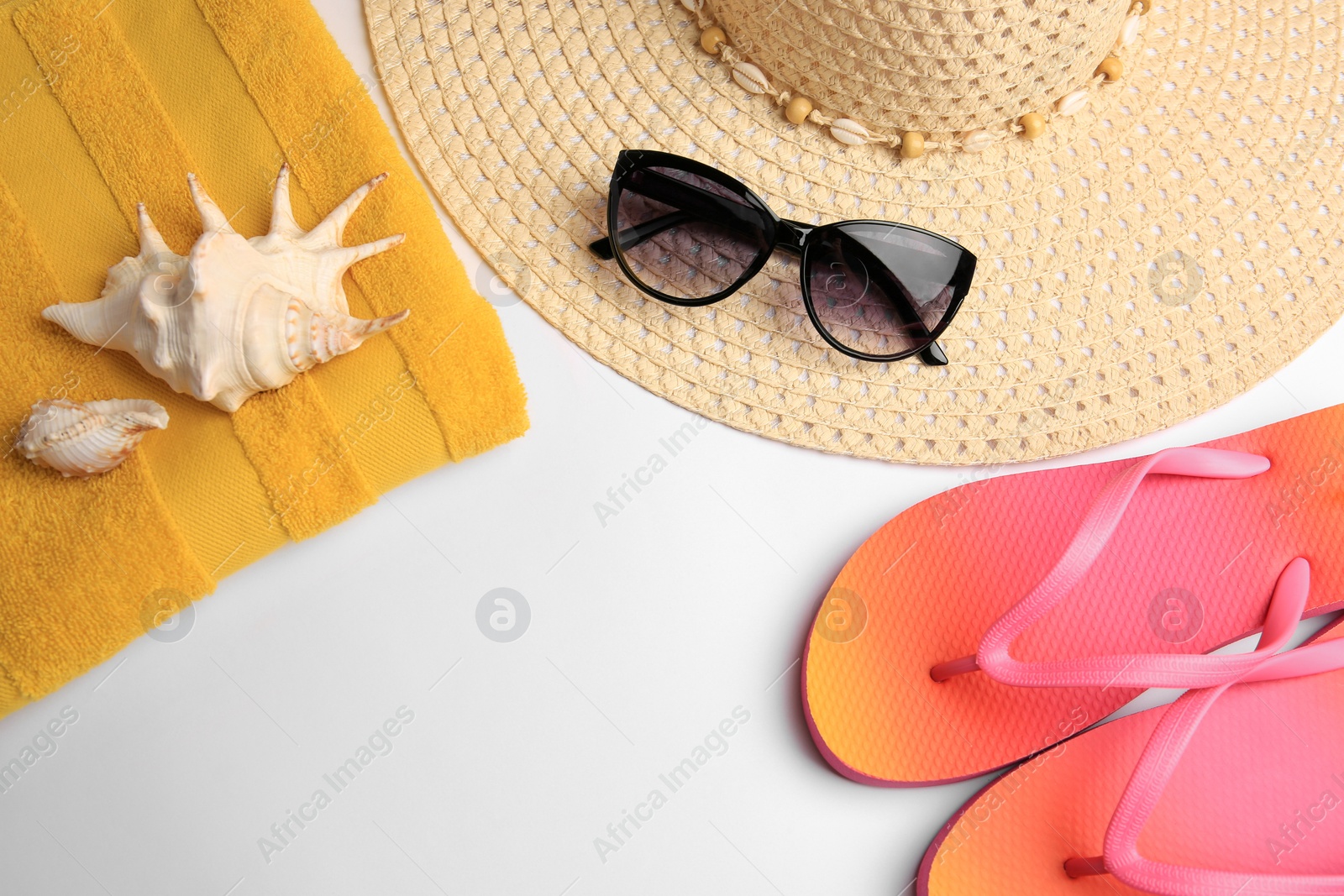 Photo of Flat lay composition with beach accessories on white background. Space for text