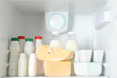 Open refrigerator with many different products, closeup