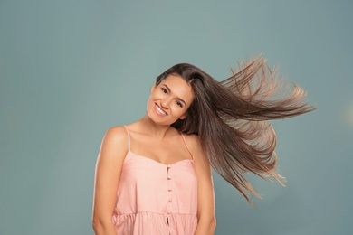 Portrait of beautiful model with gorgeous straight hair on color background