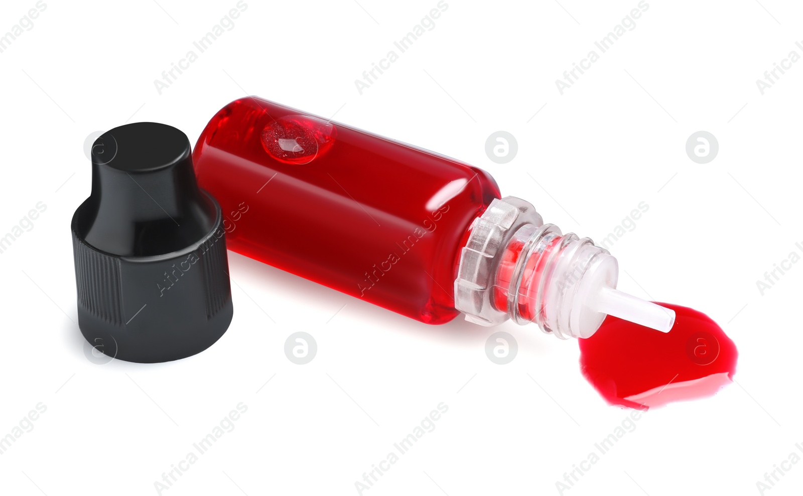 Photo of Bottle with red food coloring isolated on white