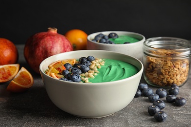 Photo of Composition with bowl of spirulina smoothie on table