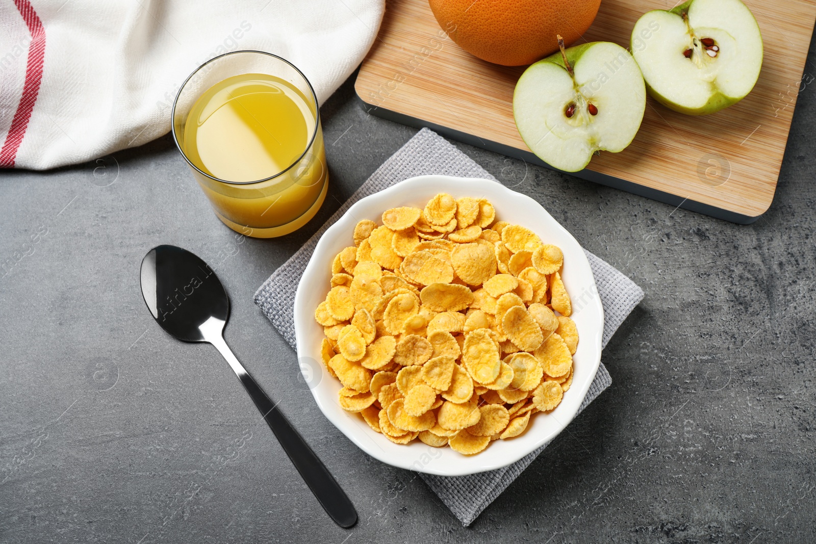 Photo of Flat lay composition with tasty corn flakes on grey table