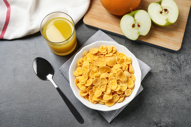 Flat lay composition with tasty corn flakes on grey table