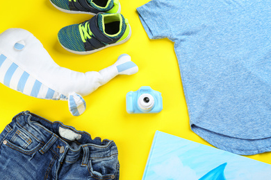 Flat lay composition with toy camera for little photographer on yellow background