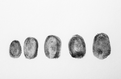 Photo of Black fingerprints on white background, top view