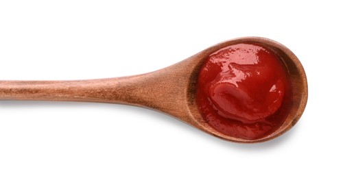 Photo of Tasty ketchup in wooden spoon isolated on white, top view