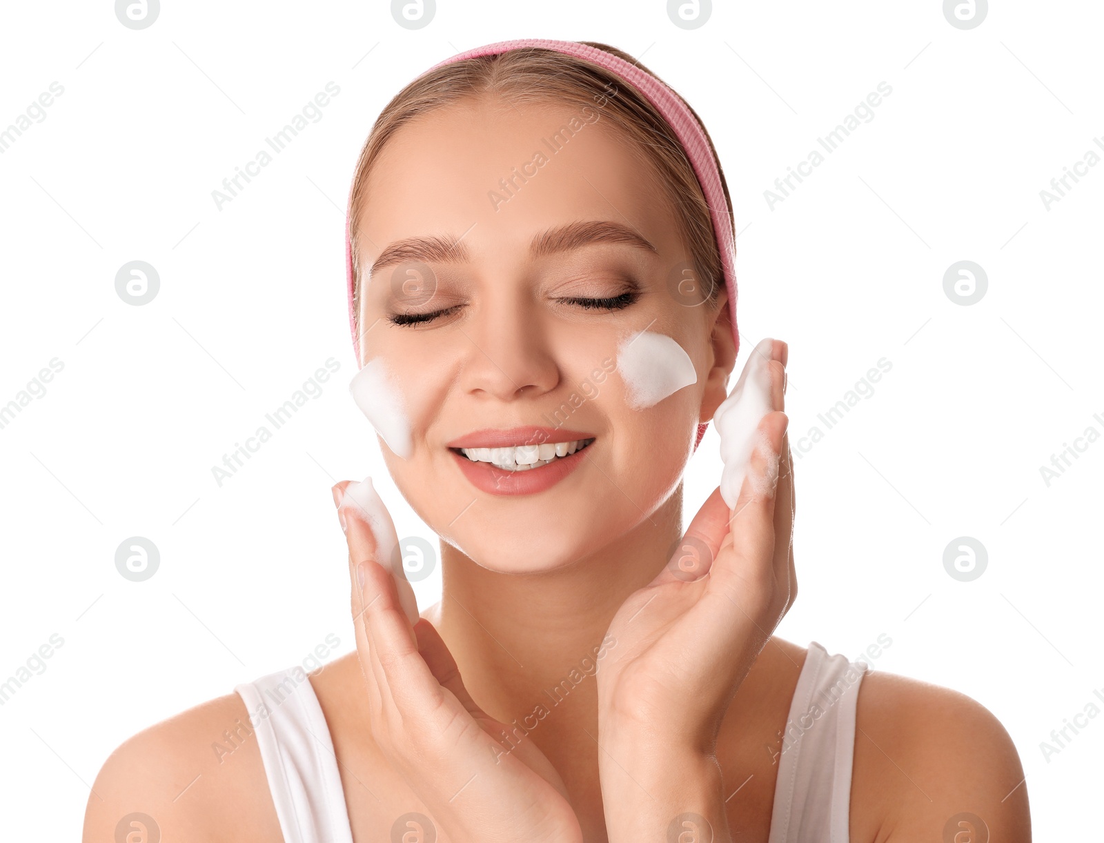 Photo of Young woman washing face with cleansing foam on white background. Cosmetic product