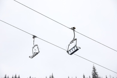 Photo of Ski lift at mountain resort. Winter vacation