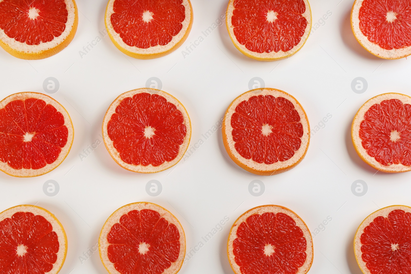 Photo of Flat lay composition with tasty ripe grapefruit slices on white background