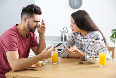 Photo of Young couple arguing at home. Problems in relationship