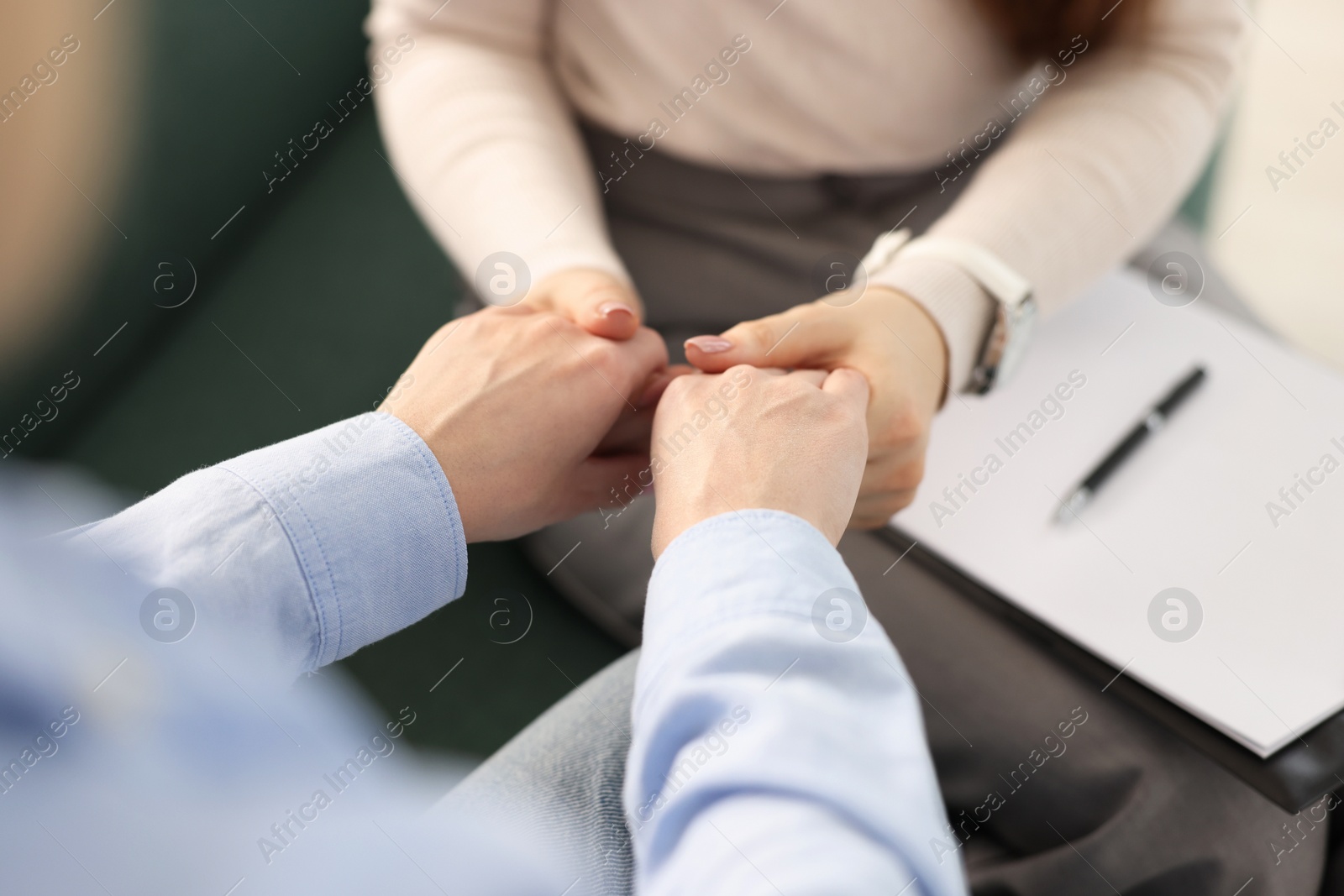 Photo of Psychotherapist working with patient in office, closeup