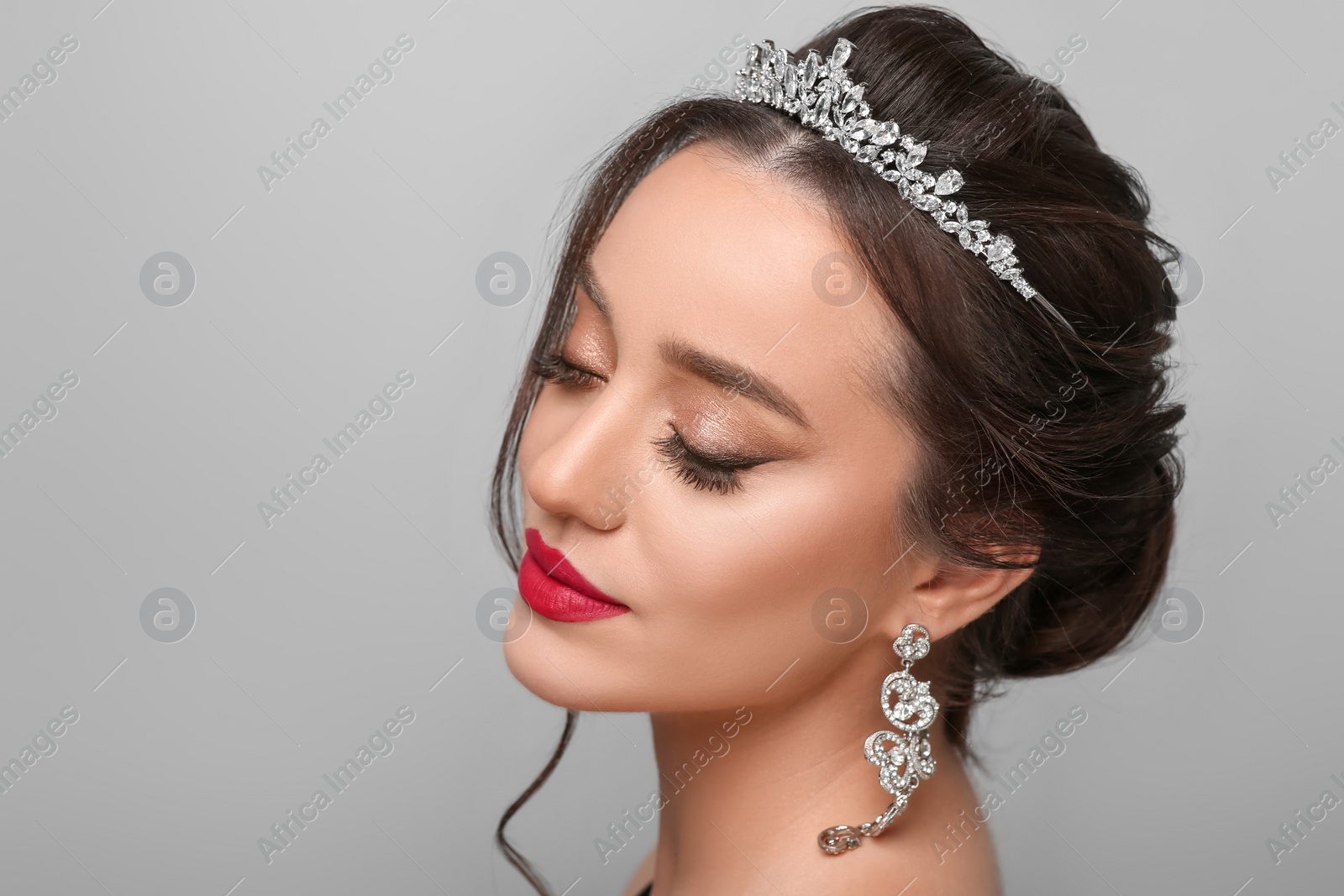 Photo of Beautiful young woman wearing luxurious tiara on light grey background. Space for text