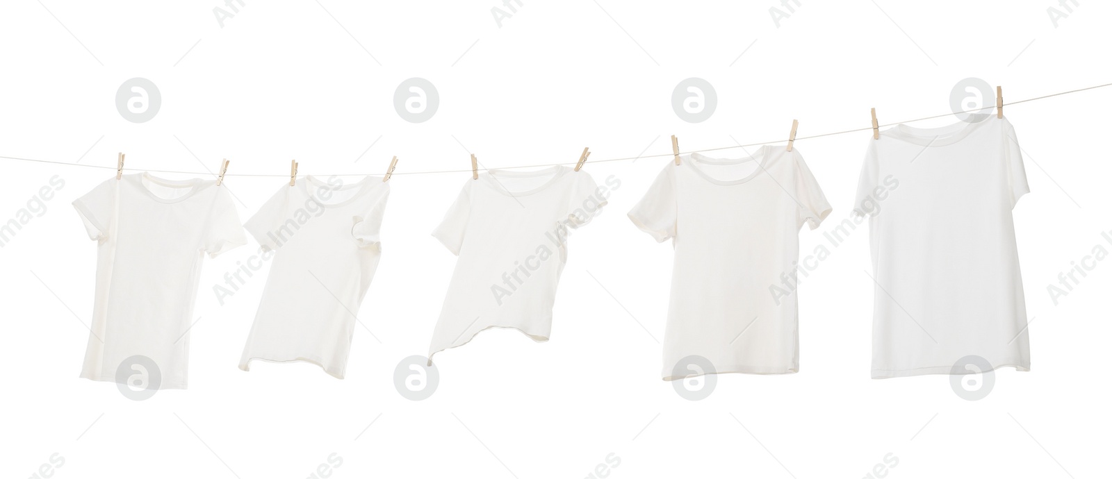 Photo of Many t-shirts drying on washing line isolated on white