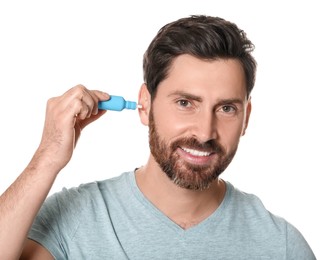 Man using ear drops on white background