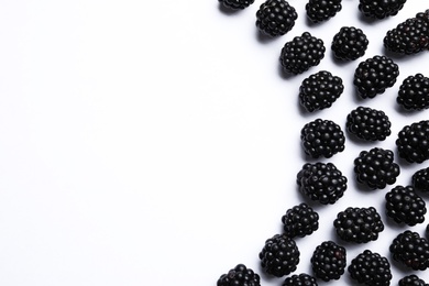 Photo of Tasty ripe blackberries on white background, flat lay. Space for text