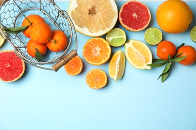 Different citrus fruits on color background, top view. Space for text